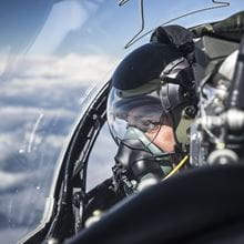close up of royal navy pilot looking out of jet canopy while in flight