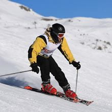 Member of the Royal Navy skiing down a slope