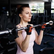 woman doing bicep curls in a gym