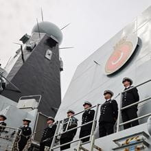 Officers of HMS Duncan on the ships upper-deck during Procedure Alpha as the ship sails for deployment