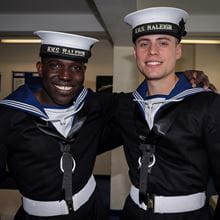 Two HMS Raleigh recruits smile at the camera 