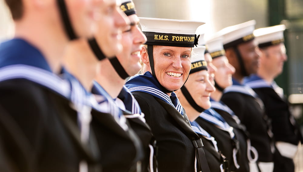 Royal Navy reservist in a line-up looking at the camera smiling