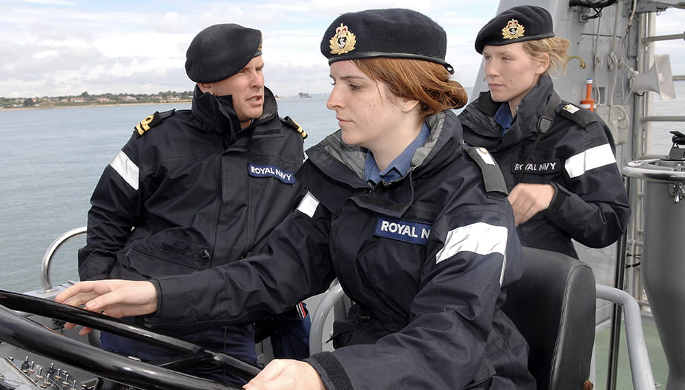Three Royal Navy personnel working. University Royal Naval Unit (URNU's) onboard HMS Archer for sea training.