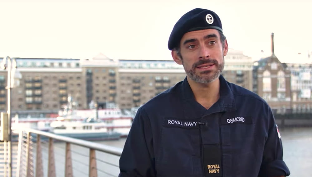 Royal Navy reservist wearing a navy blue uniform and the blue beret speaking during a video interview