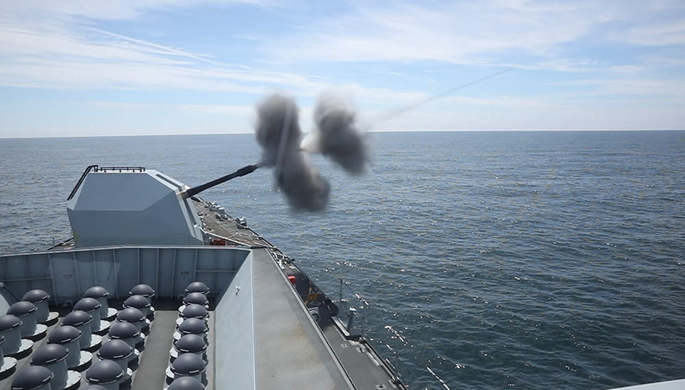 Gun on the HMS Lancaster fires a 4.5inch round out to sea