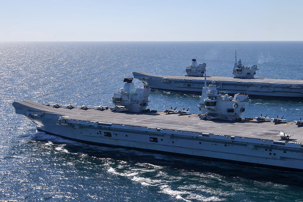 Two aircraft carriers side by side at sea
