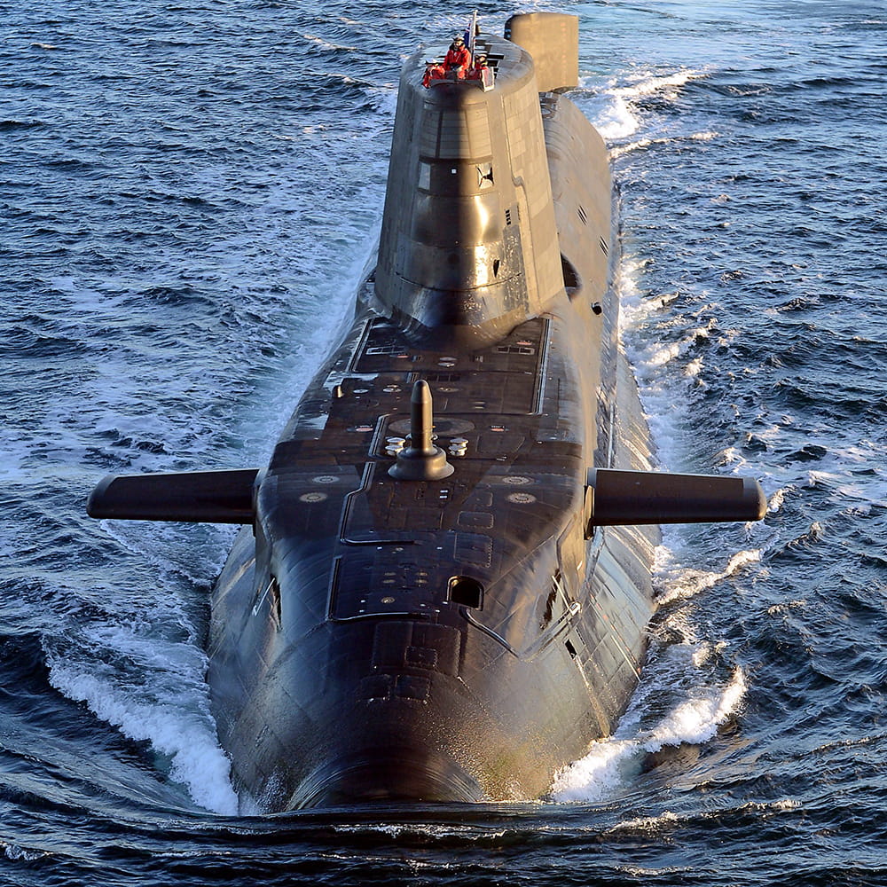 Astute submarines powers along on the surface of the water
