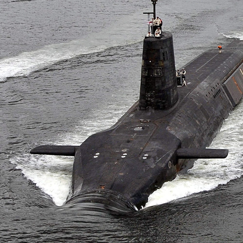 Trident submarine travels on the surface of the grey water