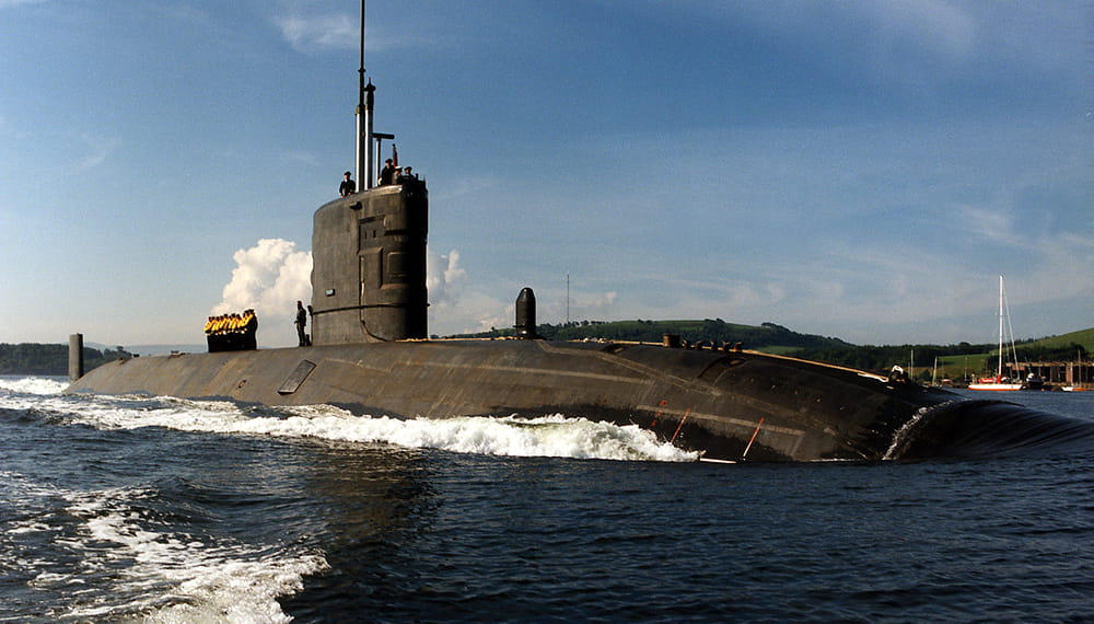 Royal Navy submarine, HMS Triumph powers along on the surface in the Clyde area of Scotland