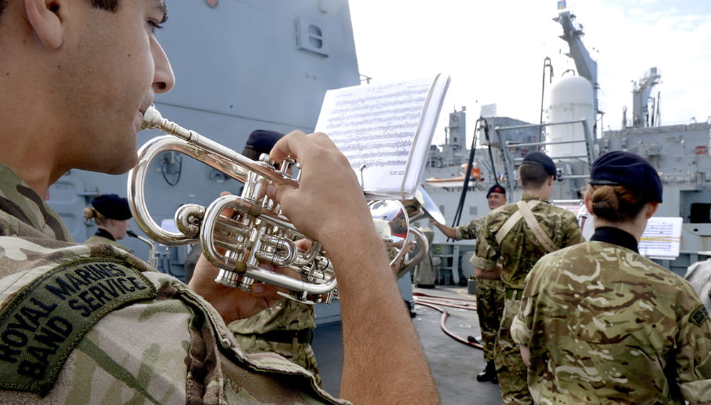 Royal Marines Band play on board a ship