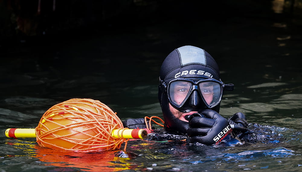 A Royal Navy diver on the surface during an underwater search