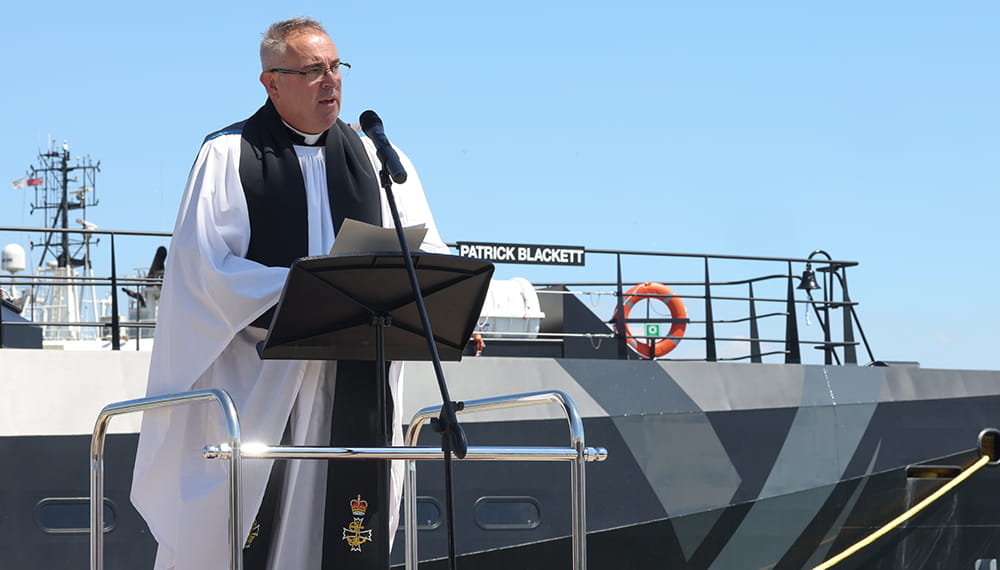 Reverend Pill Amey, HMS Nelson Chaplain, gives a blessing aboard a ship