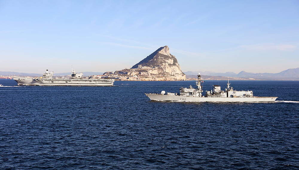 HMS Queen Elizabeth Aircraft Carrier and frigate in front of rock of Gibraltar