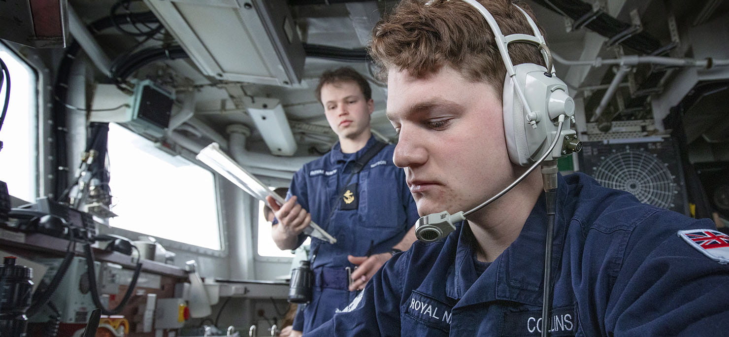 (L-R) LS(Sea Specialist) Scott Watson watches on as AB(Sea Specialist) Stanley Collins monitors communications after HMS Lancaster joins SNMG1 Units for OOW Manoeuvres in the Baltic Regions