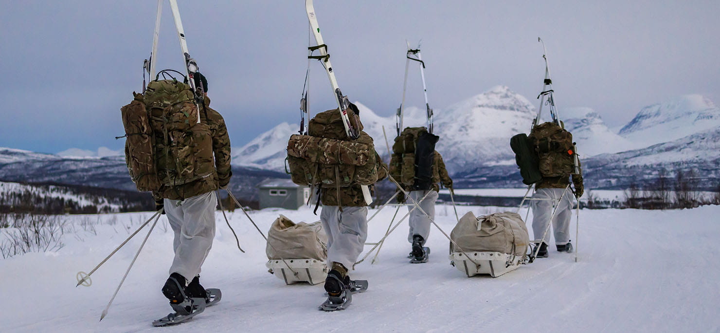 Commando Forces yomping on snow shoes and carrying their skis on the extraction from the training area during their Cold Weather Winter Warfare Course near Skjold