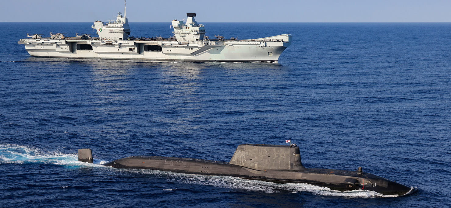  An Astute Class Submarine on the surface with HMS Queen Elizabeth in the background