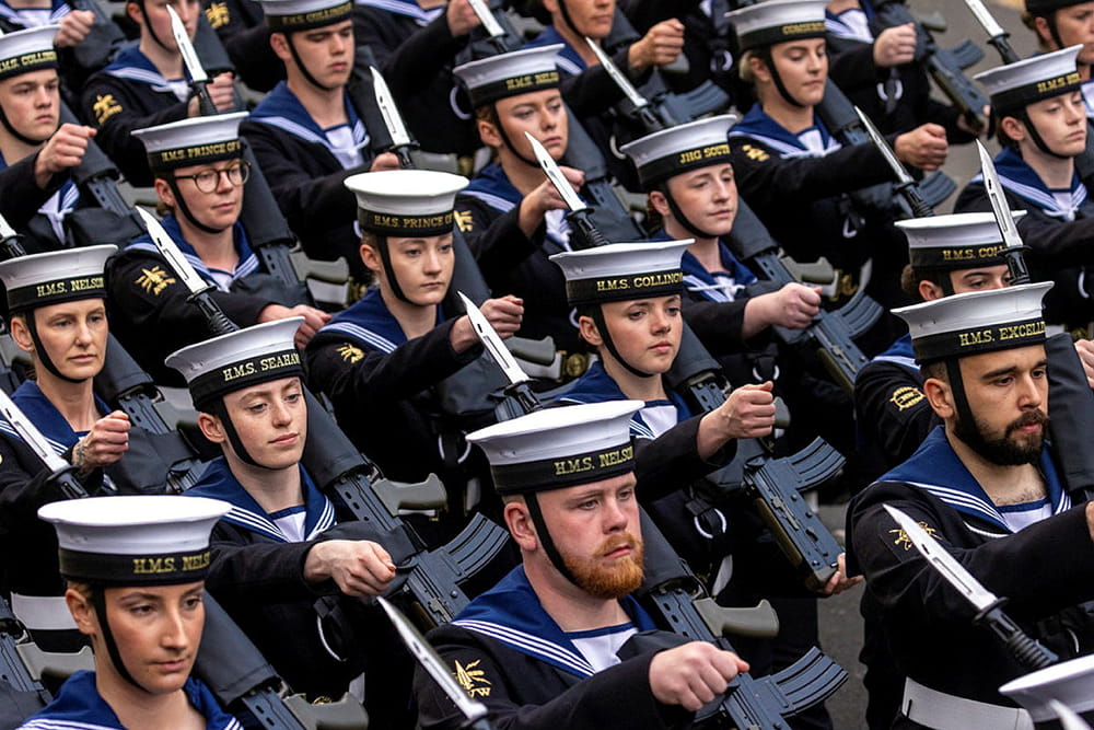 Several Royal Navy sailors marching