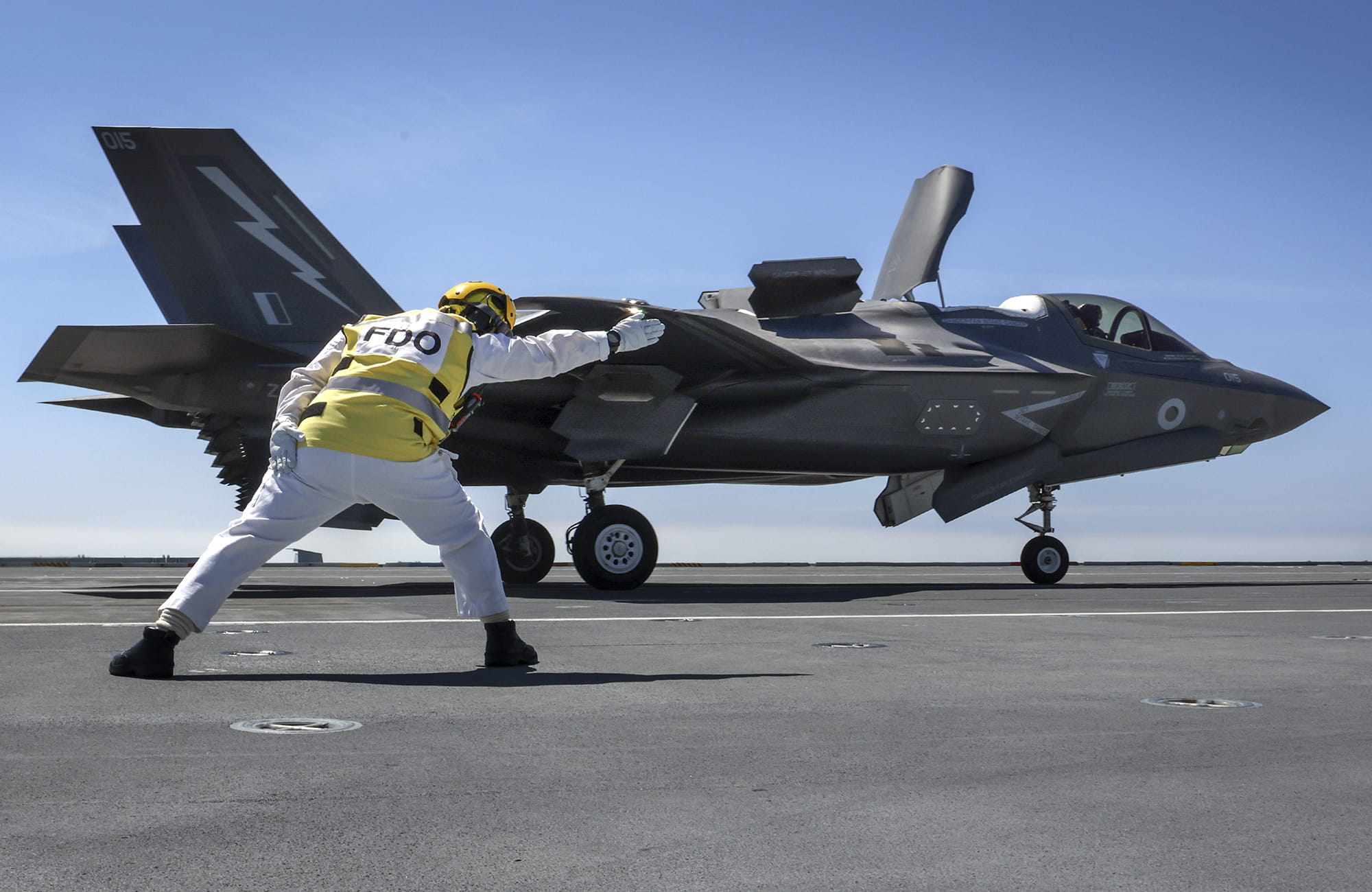 Flight deck officer onboard the HMS Prince of Wales launches F-35 Lightning