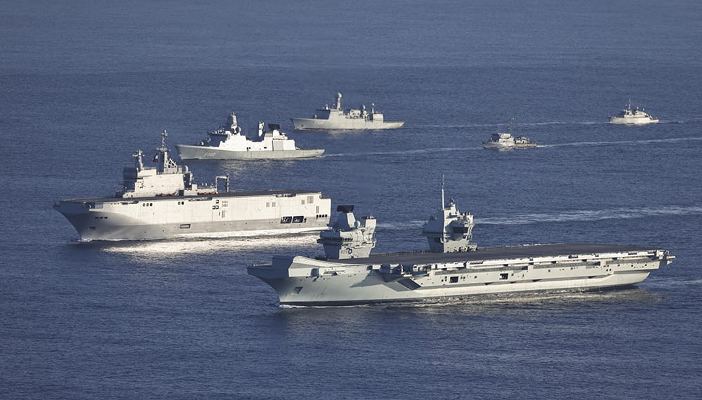 A variety of six Naval ships in the open sea