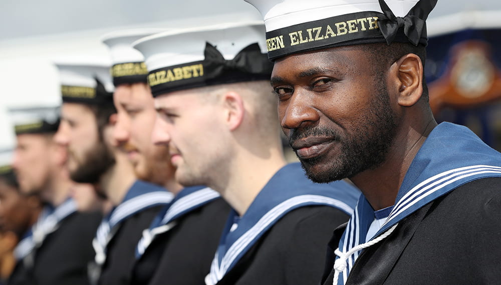 Royal Navy sailor smiles whilst on parade